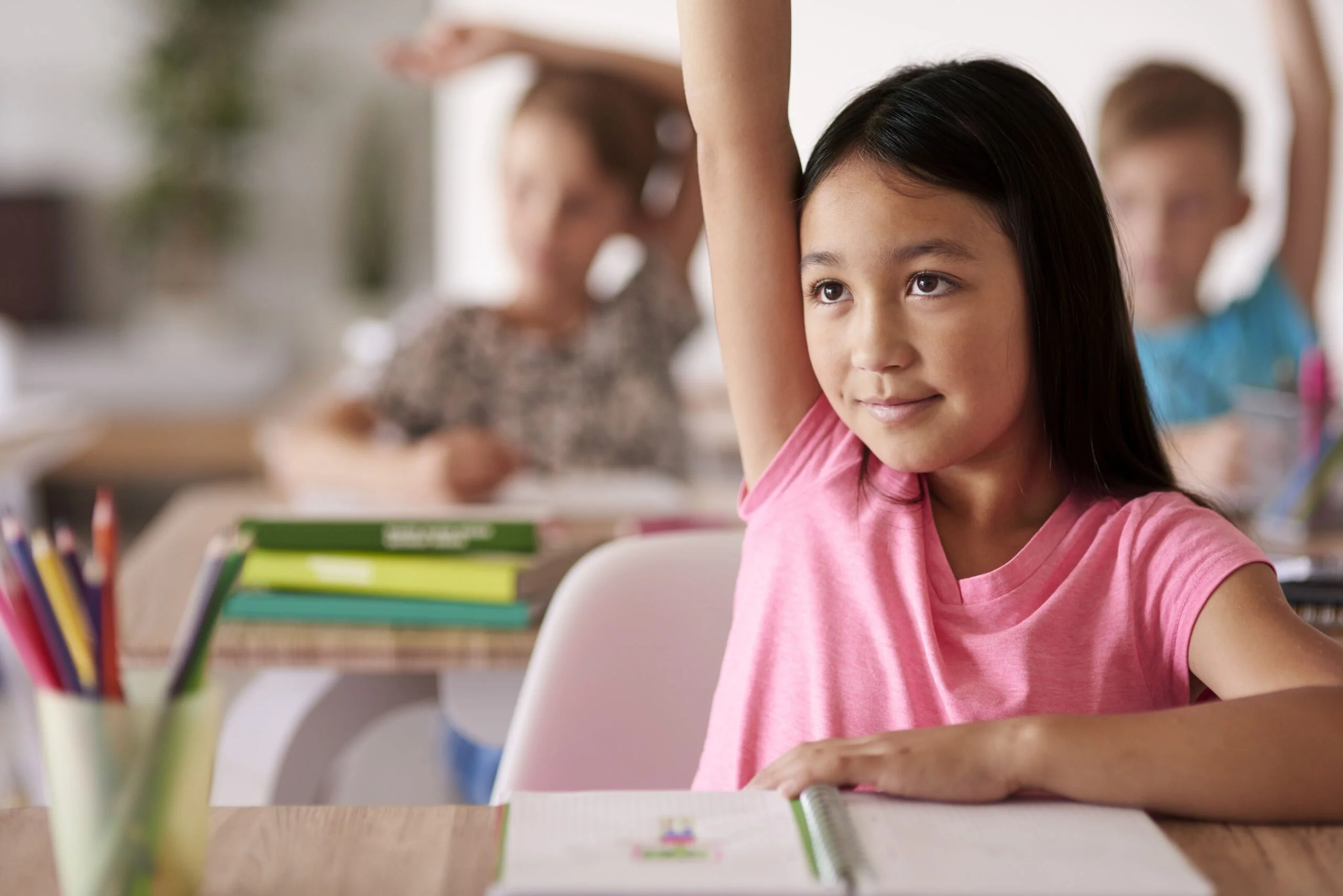 teenage student raising hand classroom 2 scaled