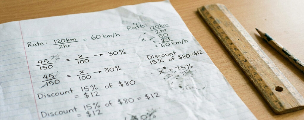 Handwritten P5 maths working showing rate and percentage calculations Singapore